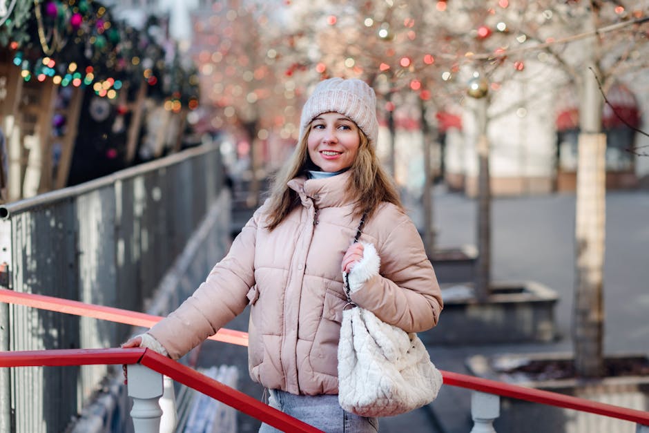 Smiling woman in winter attire explores festive urban setting with decorated trees.