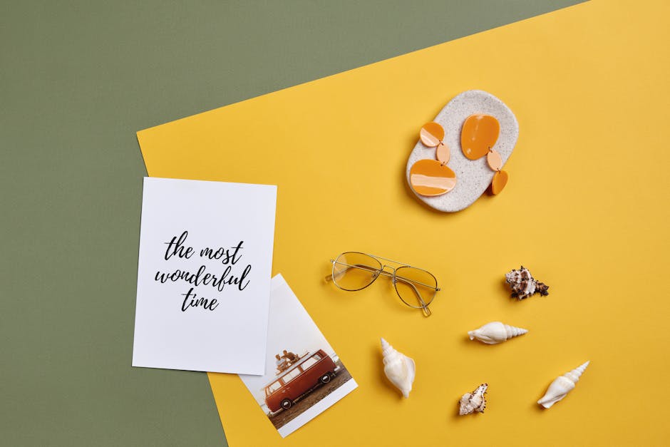 Flatlay of summer accessories and card with text 'the most wonderful time' on yellow and green background.